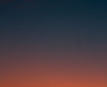 Fiery sunset with crescent moon Crescent moon and fiery orange sunset horizon